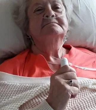 patient uses a fan donated to a hospice by hospice aid uk