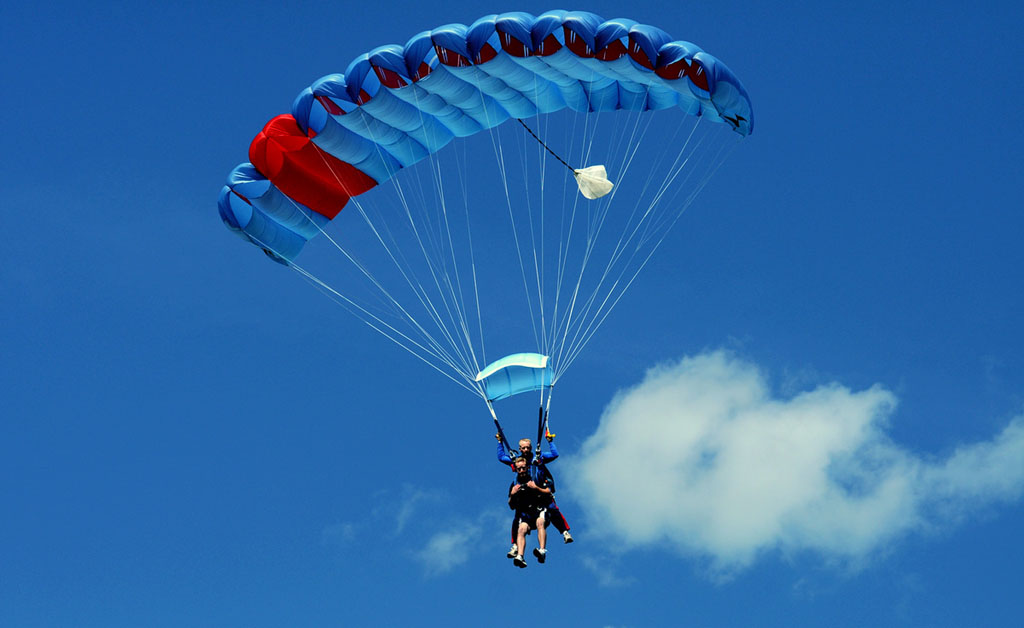 charity skydiving fundraising - parachute in blue sky