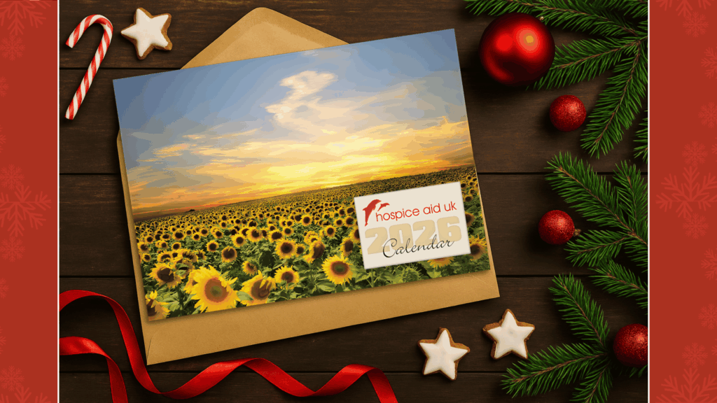 A 2026 Hospice Aid UK calendar on a Christmas background