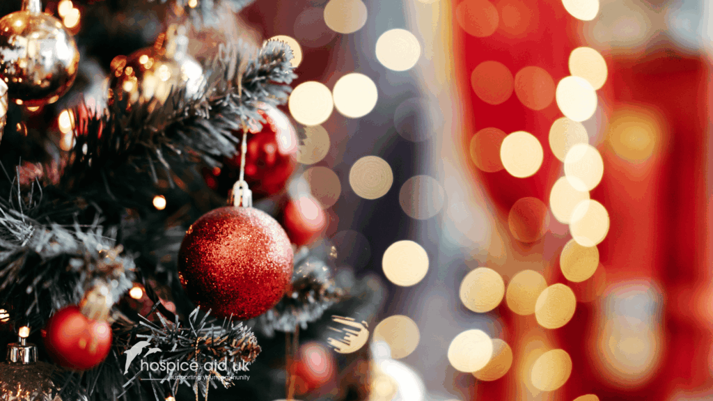 Christmas decorations, lights and baubles on a christmas tree. Red, gold and dark green colour theme
