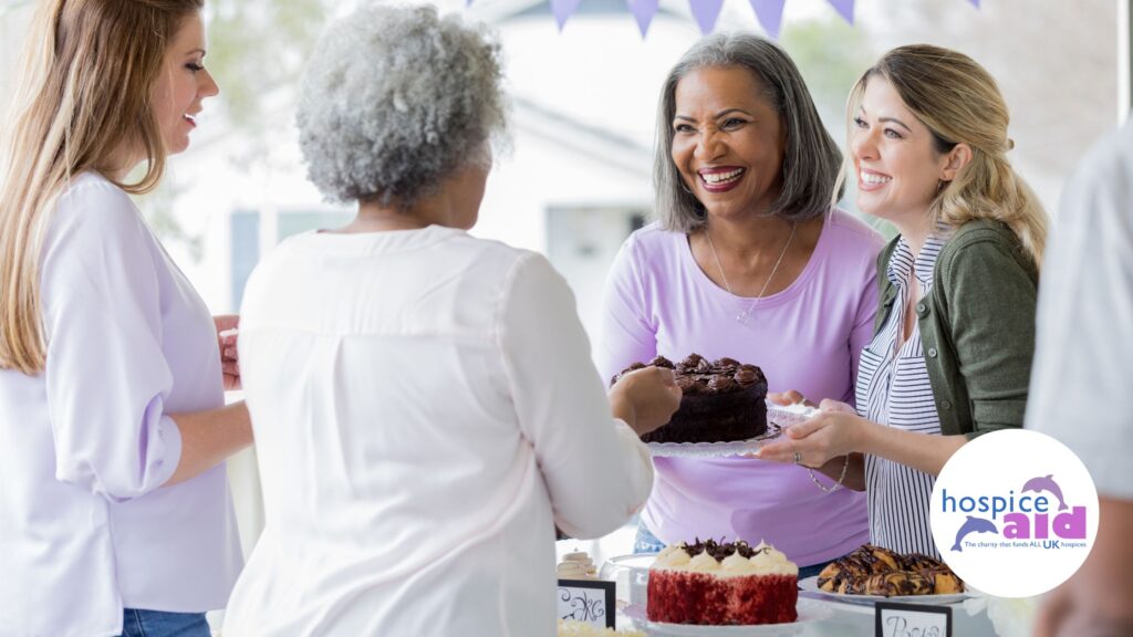 Group of ladies at an office cake sale to fundraise for hospices.